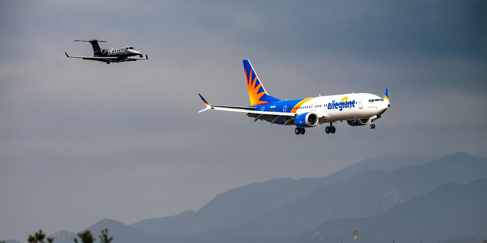 Allegiant Air Boeing 737 MAX 8-200 on approach, trailed by a smaller camera aircraft