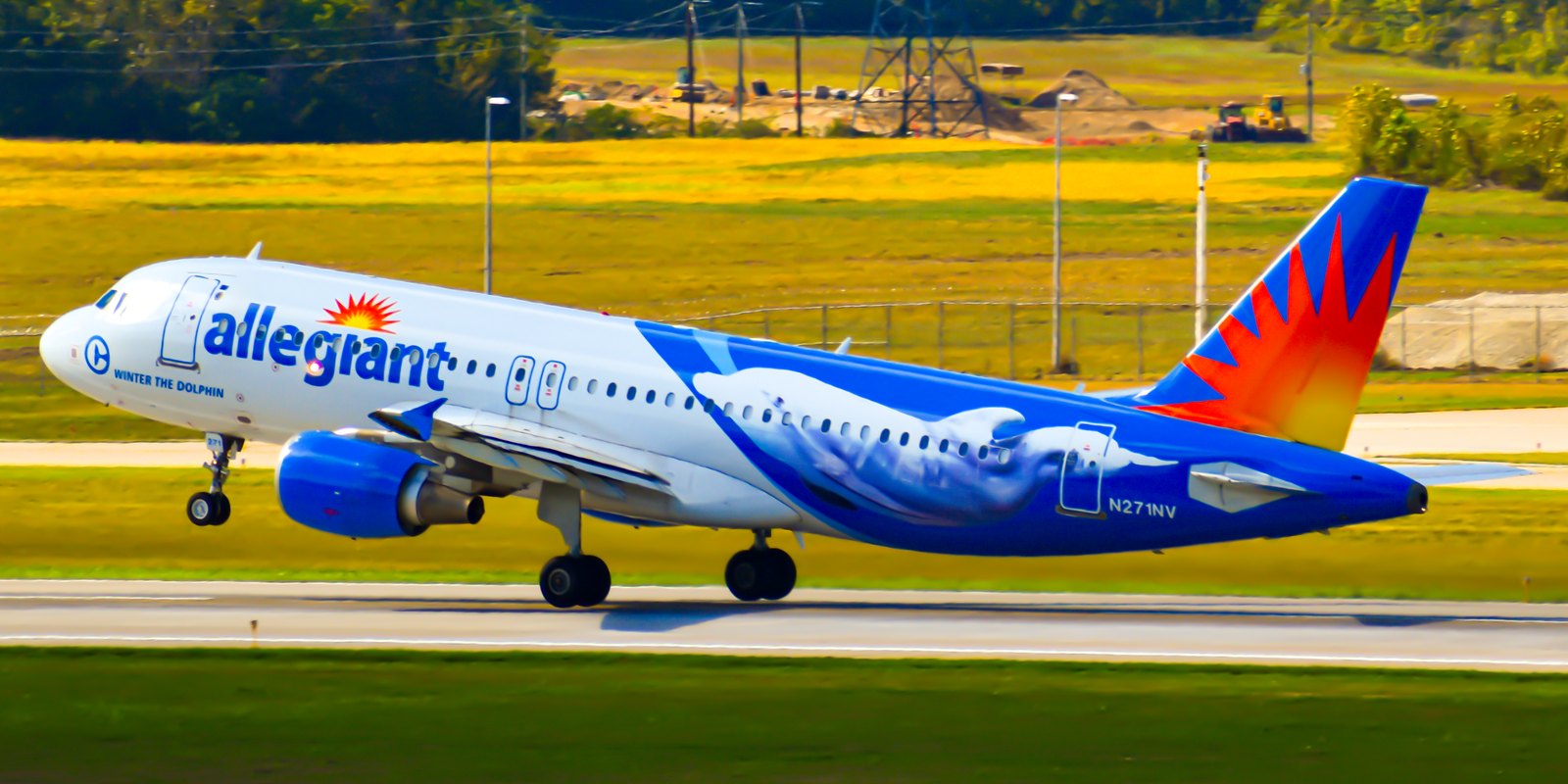 Allegiant Air Airbus A320 taking off, in the airline's blue livery with a sunburst on the tail